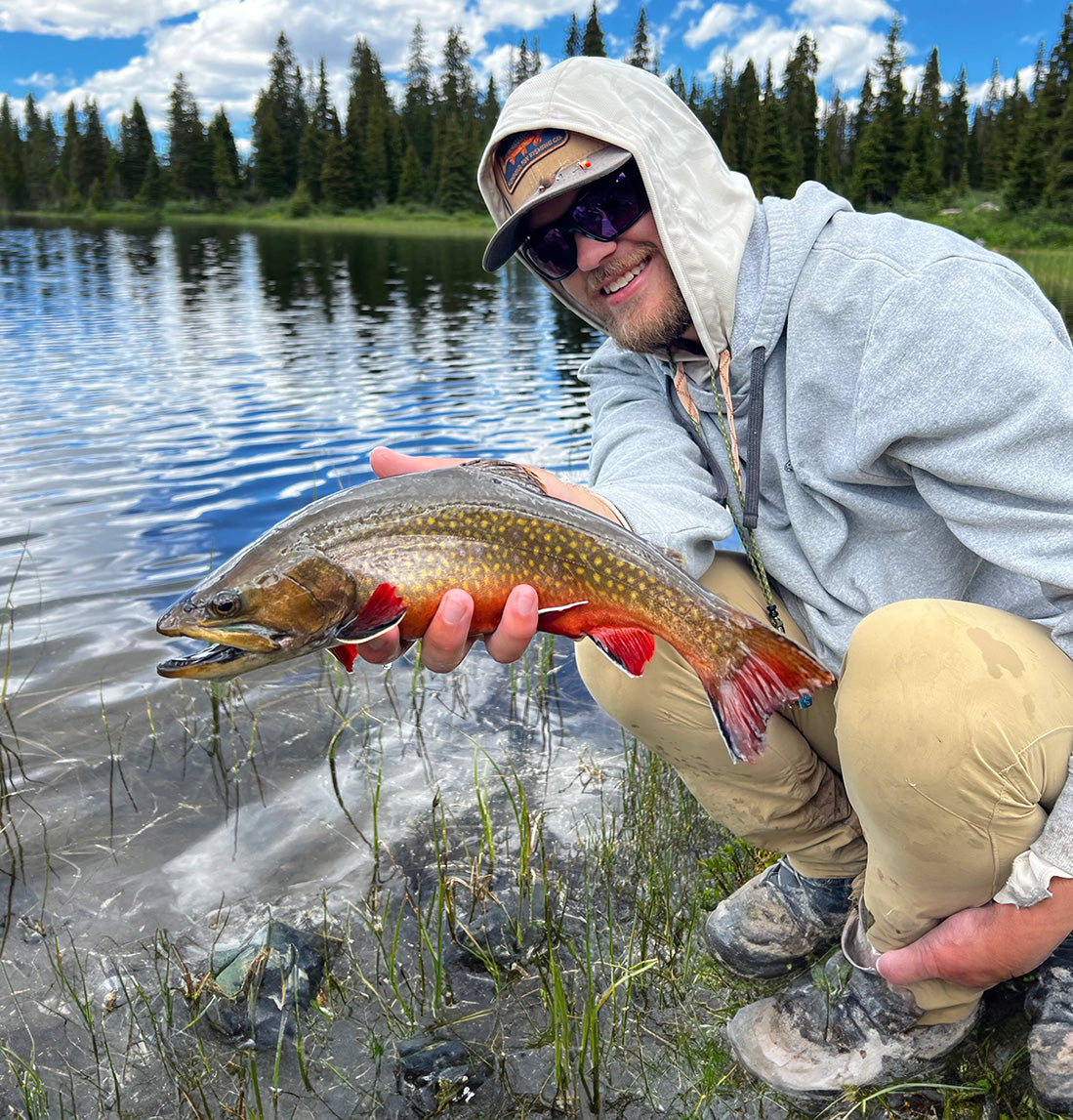 Xavier holding a brook trout