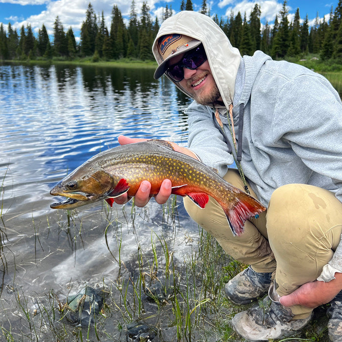 Xavier holding a brook trout